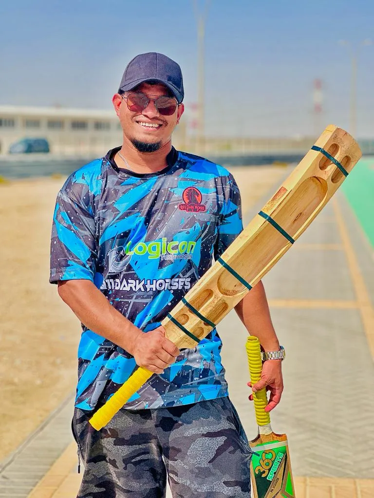Habib at a cricket ground holding a bat and ball
