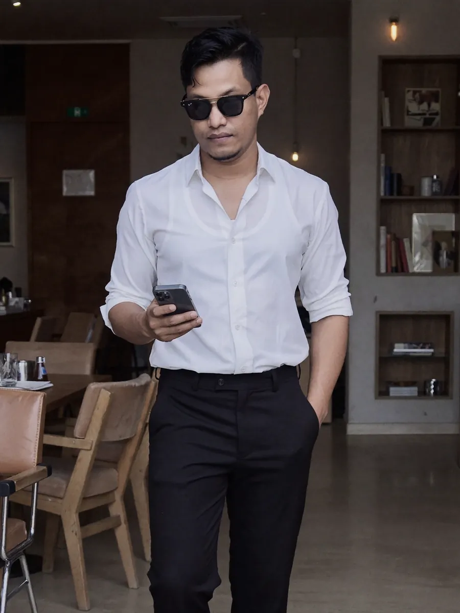 AI-generated image of Habib in a white shirt inside a café
